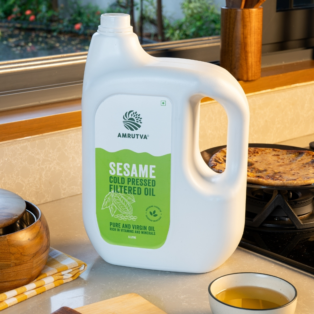 bottle of 5 liter sesame oil cold pressed filtered oil in kitchen setup by amrutva fine foods llp