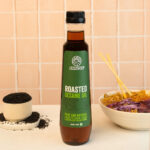 Roasted sesame oil 500 ml with kitchen background having salad dressing use case shown