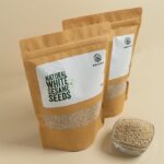Amrutva premium white sesame seeds in a kraft bag; showcasing their natural quality. Ideal for adding a nutritious boost to meals or for making cold pressed sesame oil.