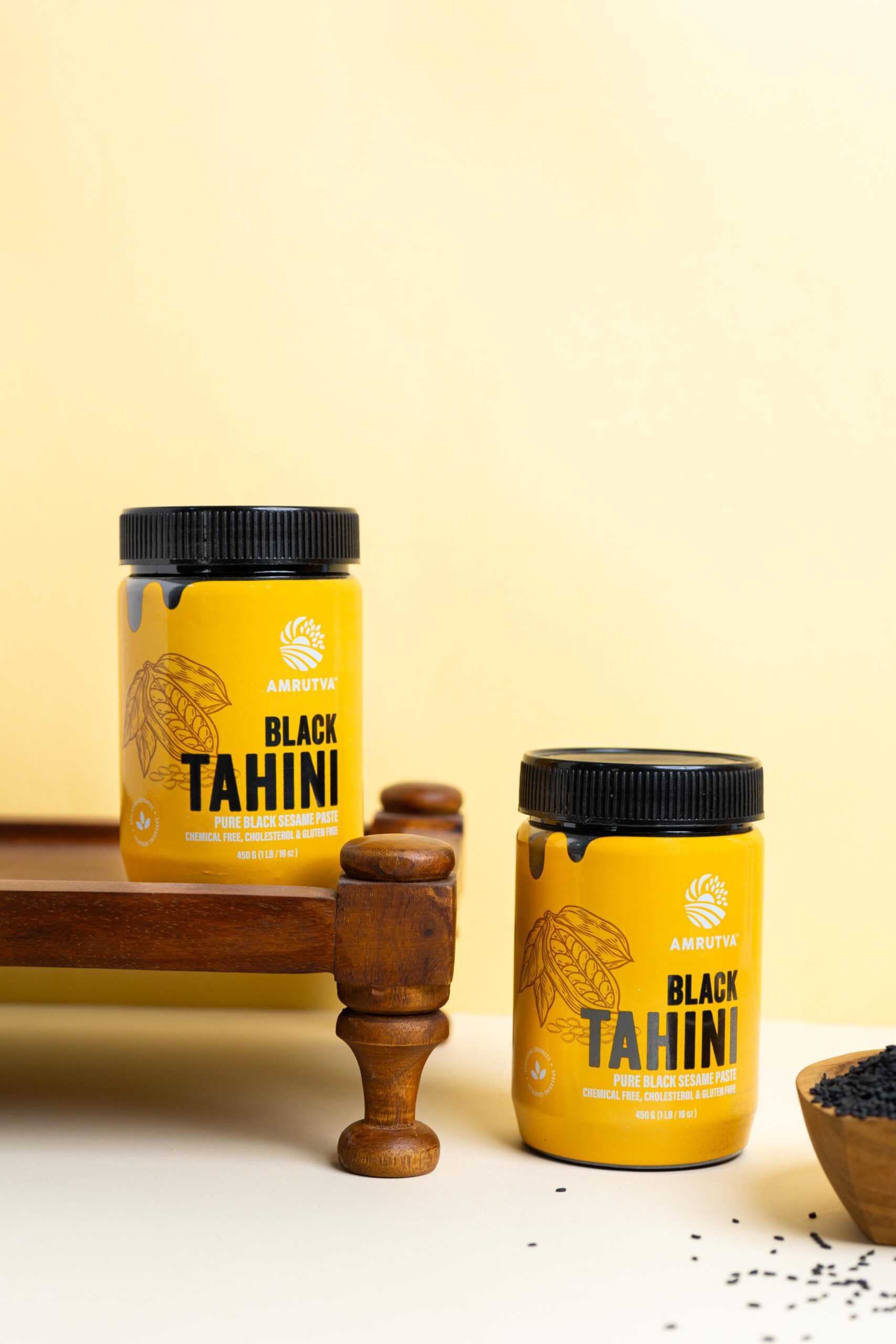 Two jars of Amrutva Black Tahini; made with premium black sesame seeds. Perfect for hummus; dips; and other recipes.